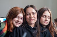 Group of Teen Girls Smiling Together Indoors