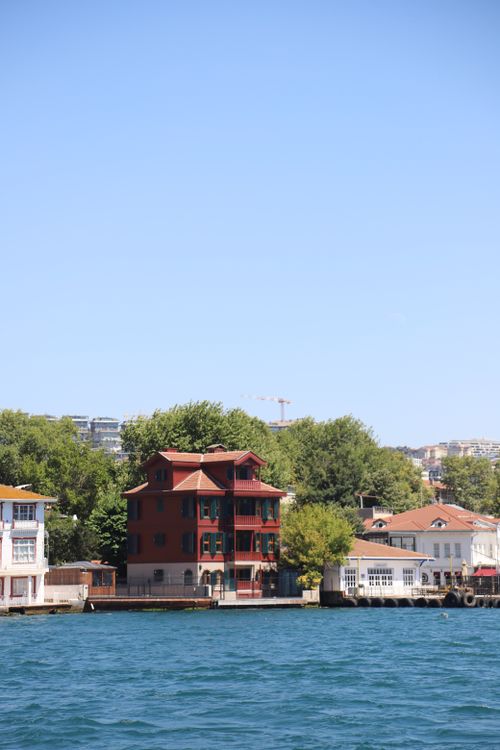 Free Picturesque waterfront houses along the Bosphorus under clear blue skies. Stock Photo