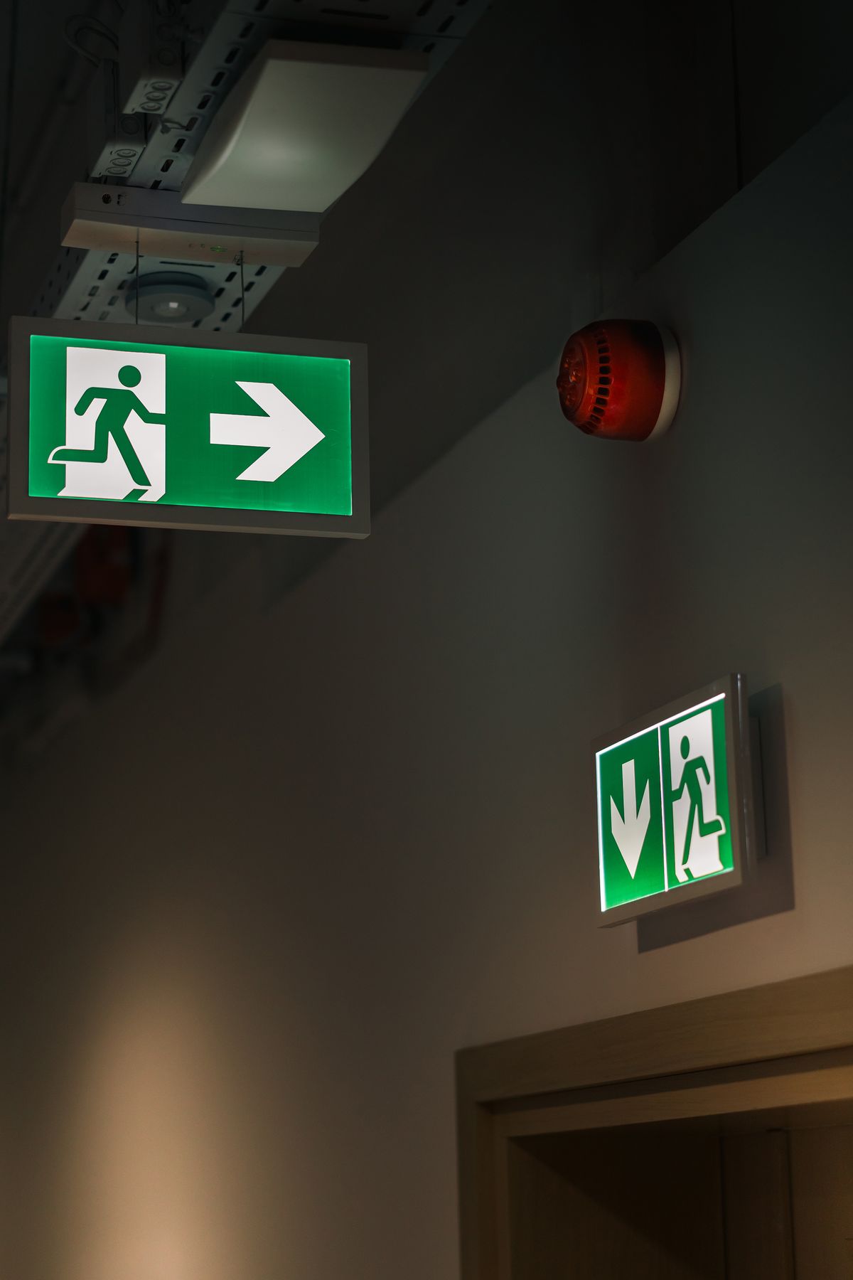 Exit Sign In Hall Illuminated Emergency Exit Sign in Corridor · Free Stock Photo