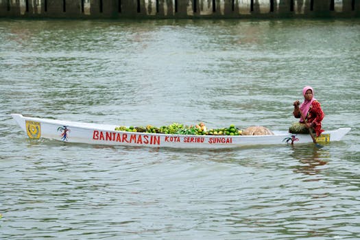 A woman sells fresh produce from a traditional boat in Banjarmasin, Indonesia.