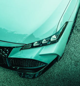 Detailed image of a sleek car's headlight design, showcasing modern automotive style.