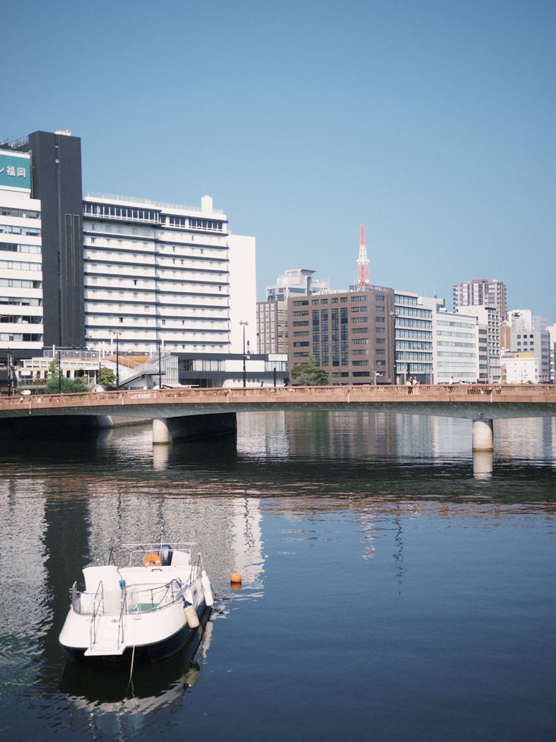Fukuoka riverfront with boat — the Naka River waterfront that defines the city's geography