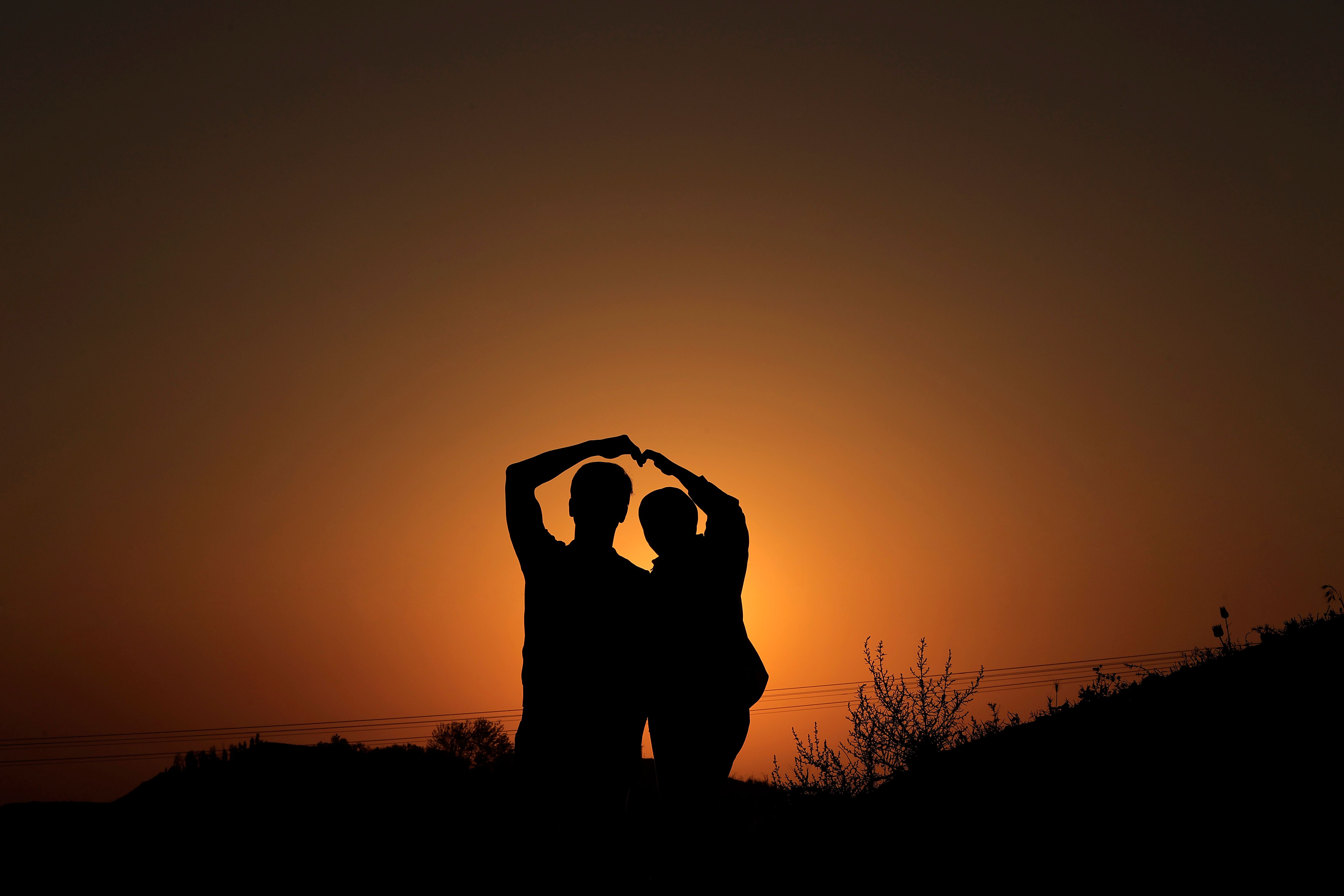 Couple Silhouette Embracing at Sunset · Free Stock Photo