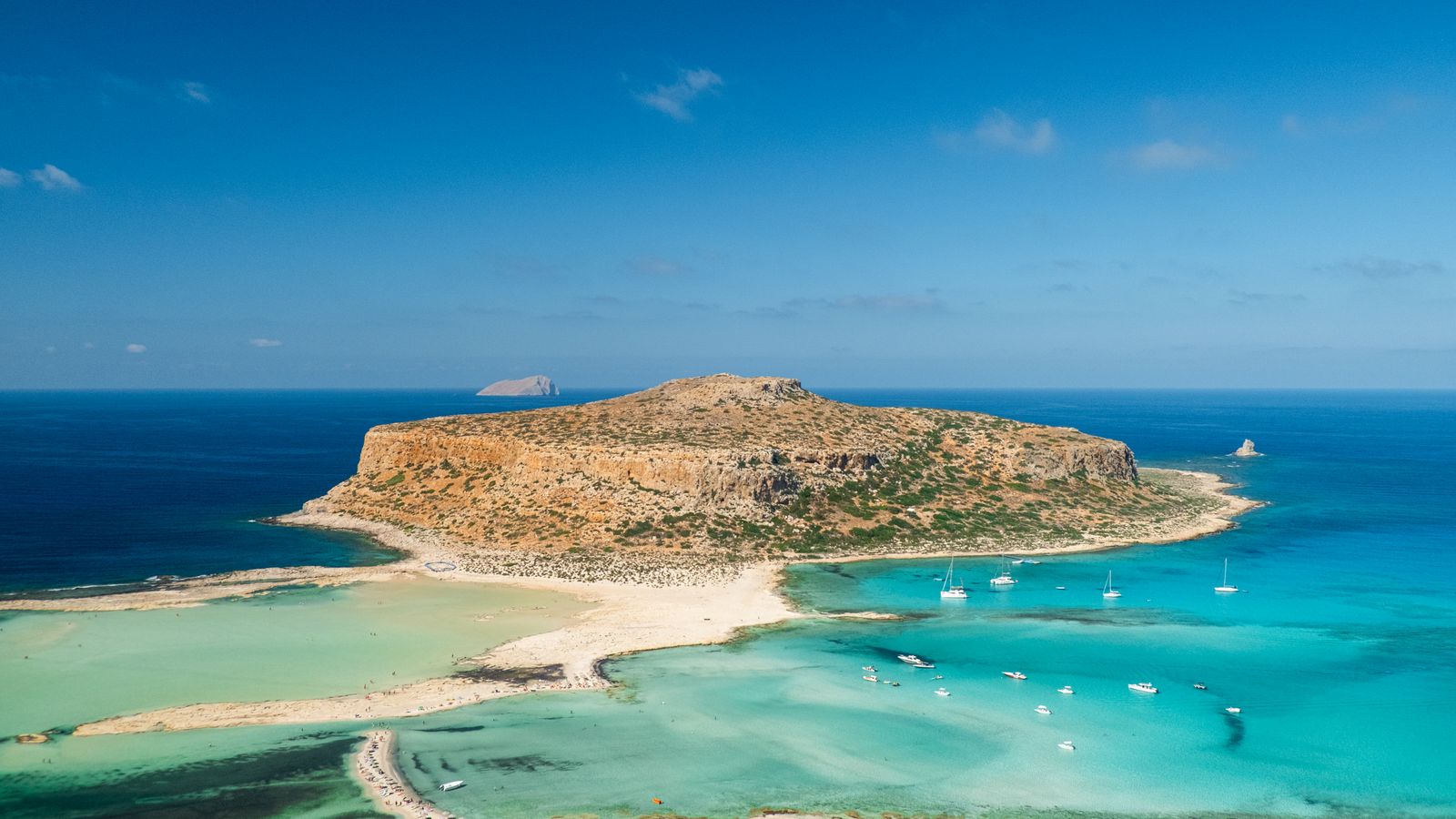 Aerial view of Balos lagoon in Crete — turquoise shallows sweeping toward the headland