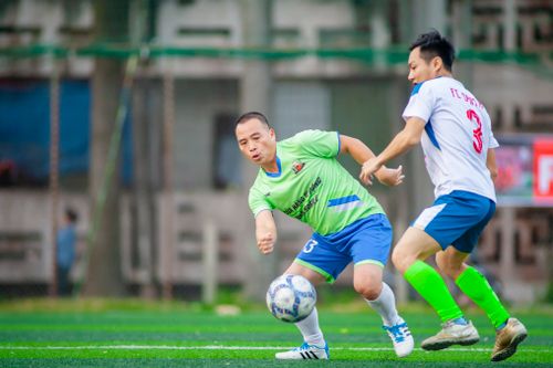 Free Two soccer players compete fiercely on a vibrant green field in Hà Nội, Vietnam. Stock Photo