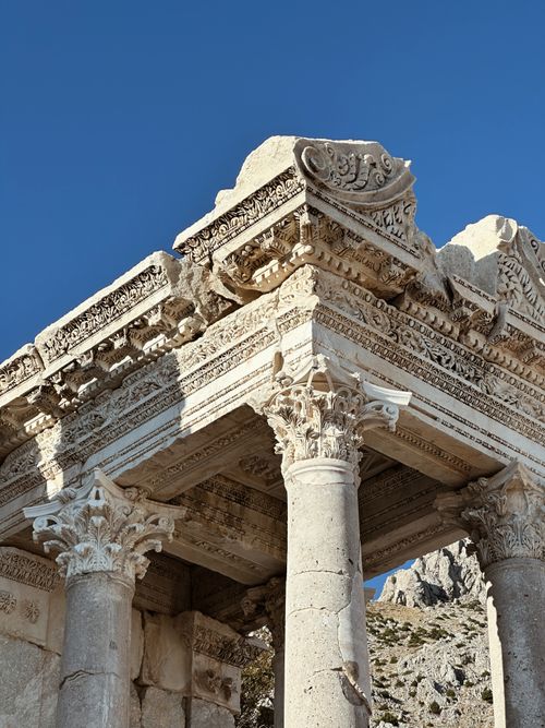 Free Explore the intricate details of ancient Roman temple ruins in Burdur, Türkiye, under a clear blue sky. Stock Photo