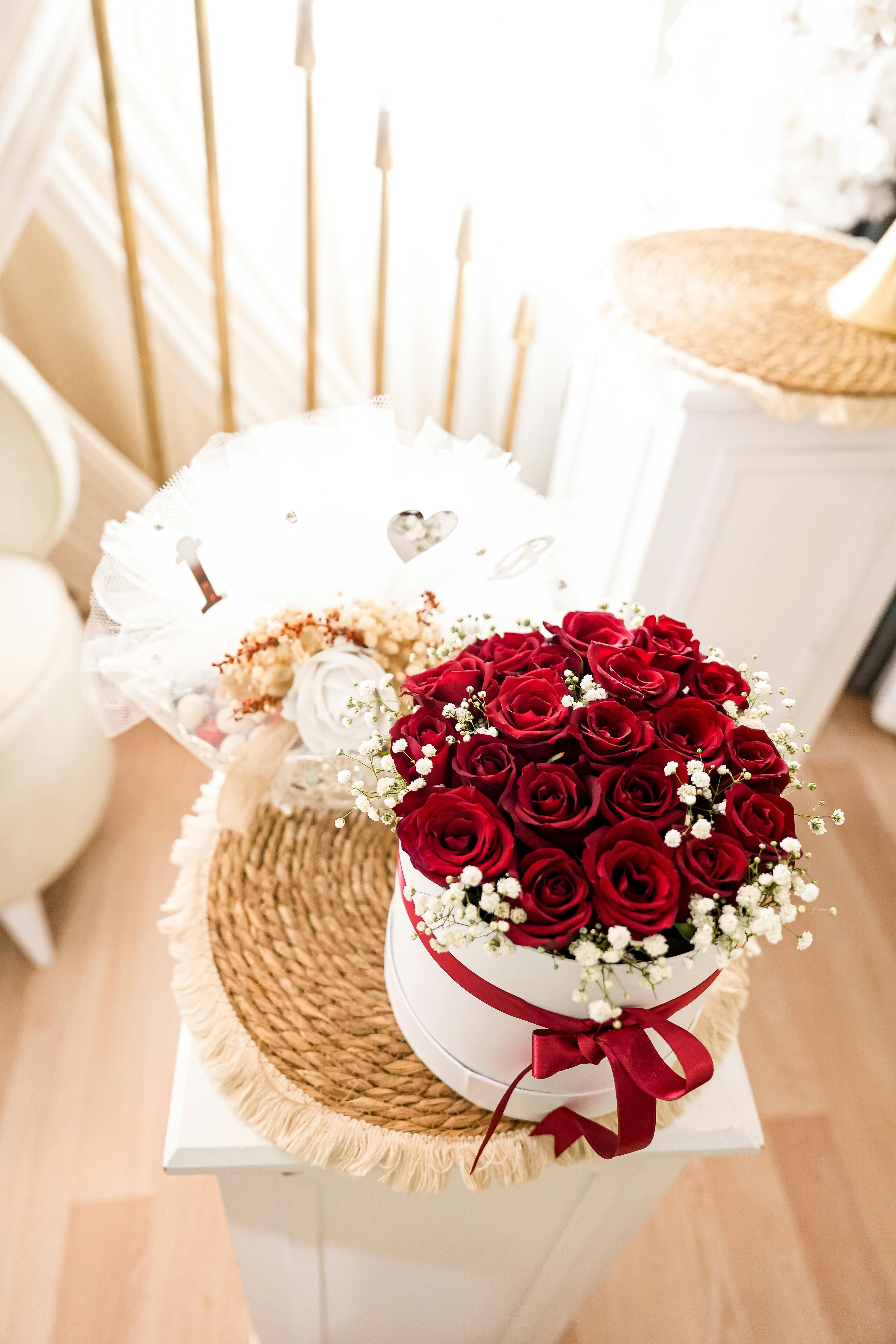 Beautiful arrangement of red roses in a white gift box, perfect for celebrations.