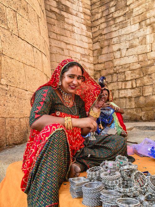 Free Capture of Rajasthani women in traditional attire selling jewelry at a market stall. Stock Photo