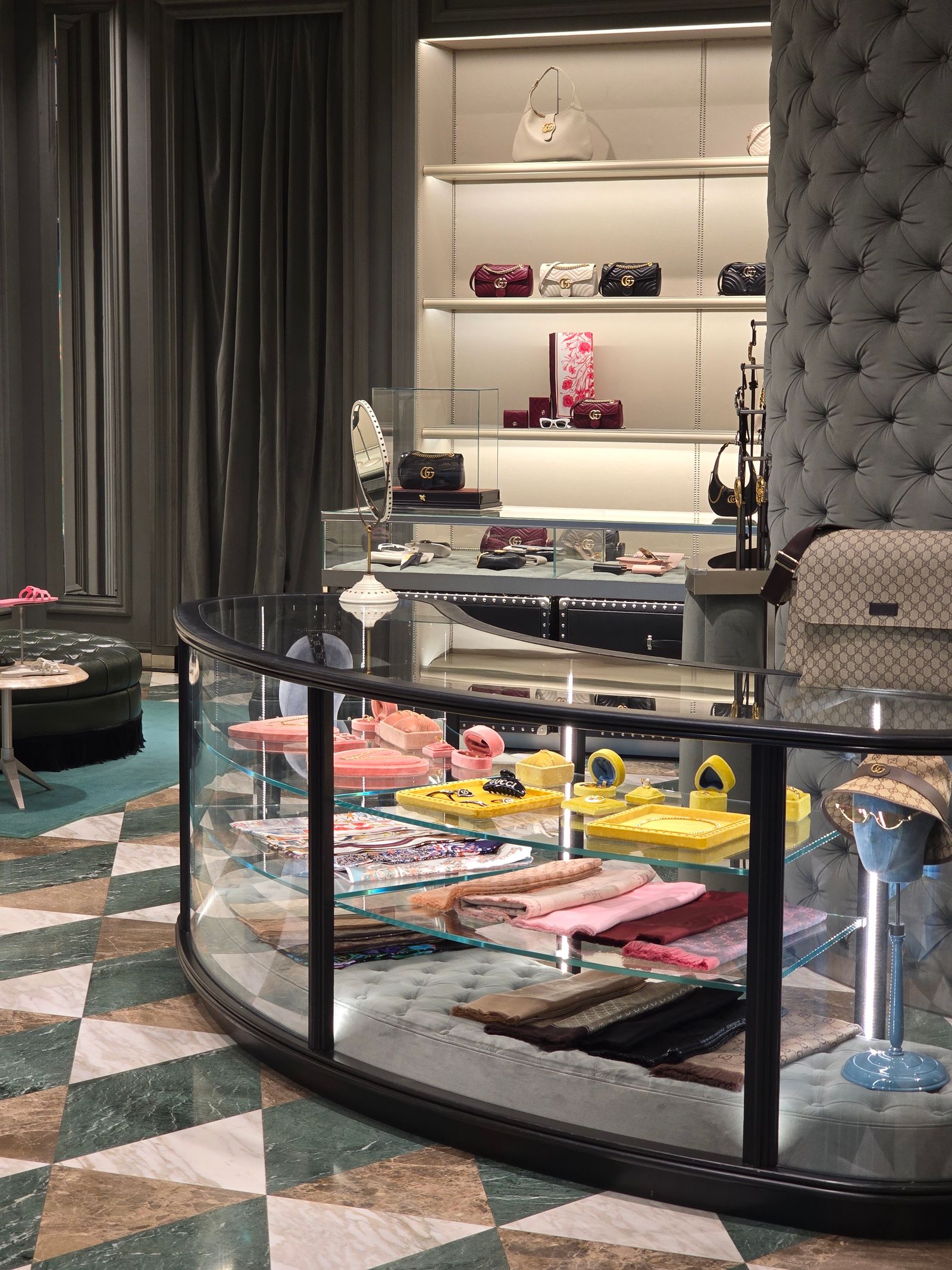 Luxury retail boutique interior with display shelving and accessories.