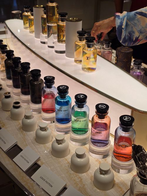 Free A vibrant display of luxury perfume bottles in various colors and fragrances. Stock Photo