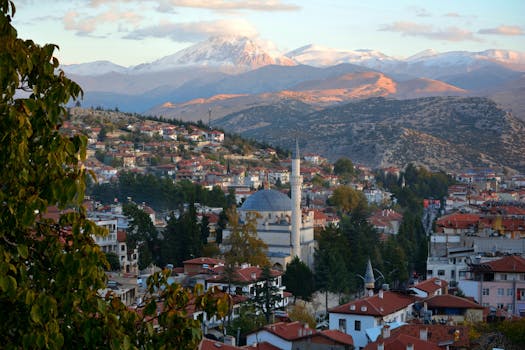 Picturesque Elmalı town in Antalya, Türkiye, with stunning snow-capped mountains in the background.