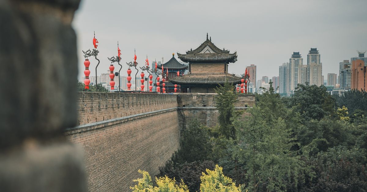 View of the historic Xi'an City Wall with urban skyline in the background, blending tradition and modernity.