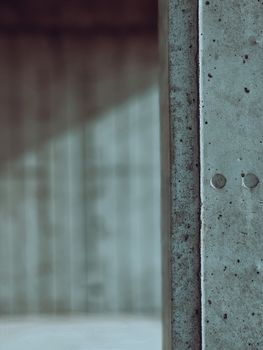 A close-up view of a textured concrete wall with soft lighting and minimalist aesthetics.