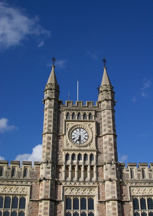 Free A detailed view of a historic clock tower against a clear blue sky in Bristol, UK. Stock Photo