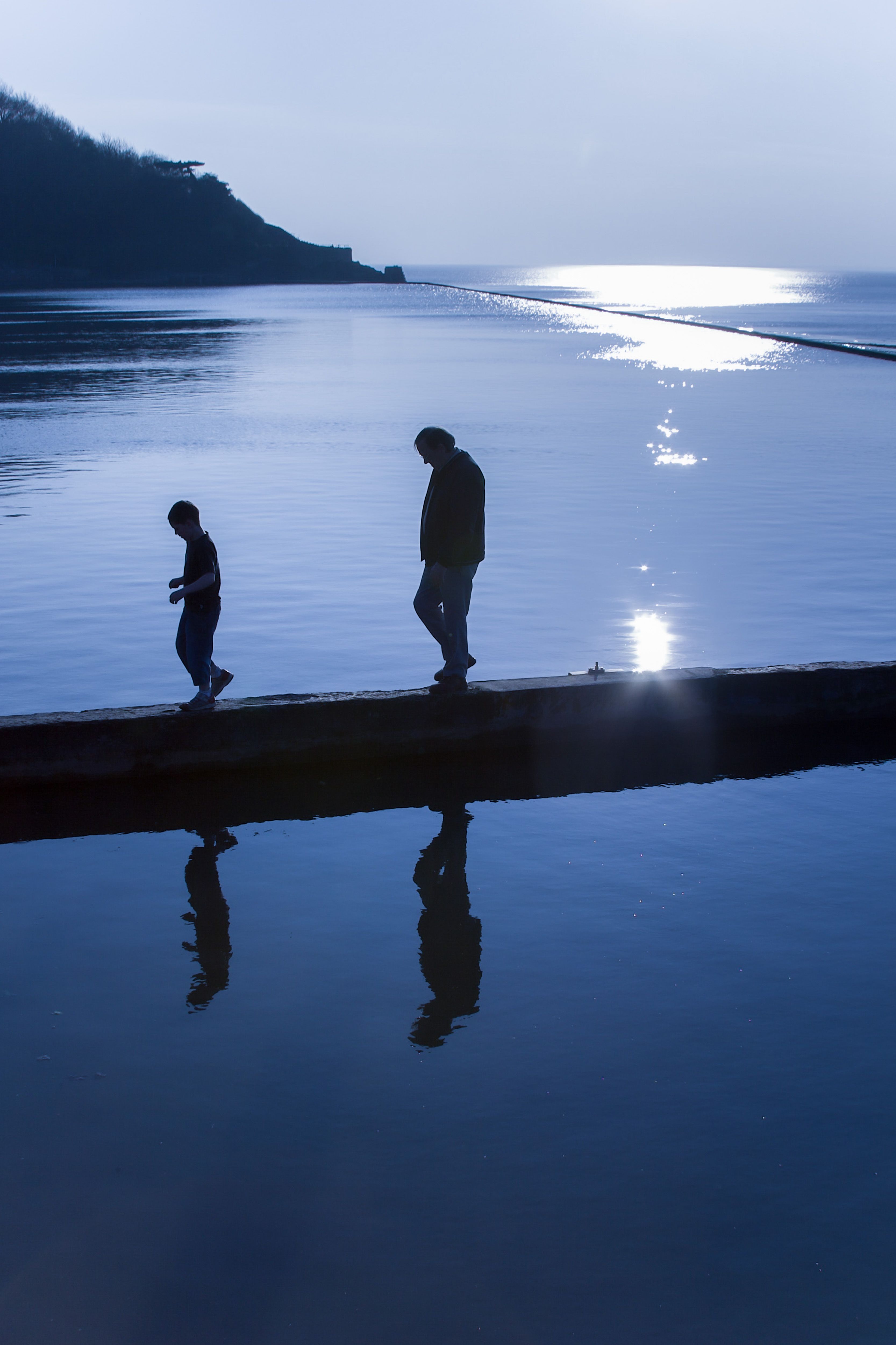 Silhouettes Walking by the Water in Bristol · Free Stock Photo