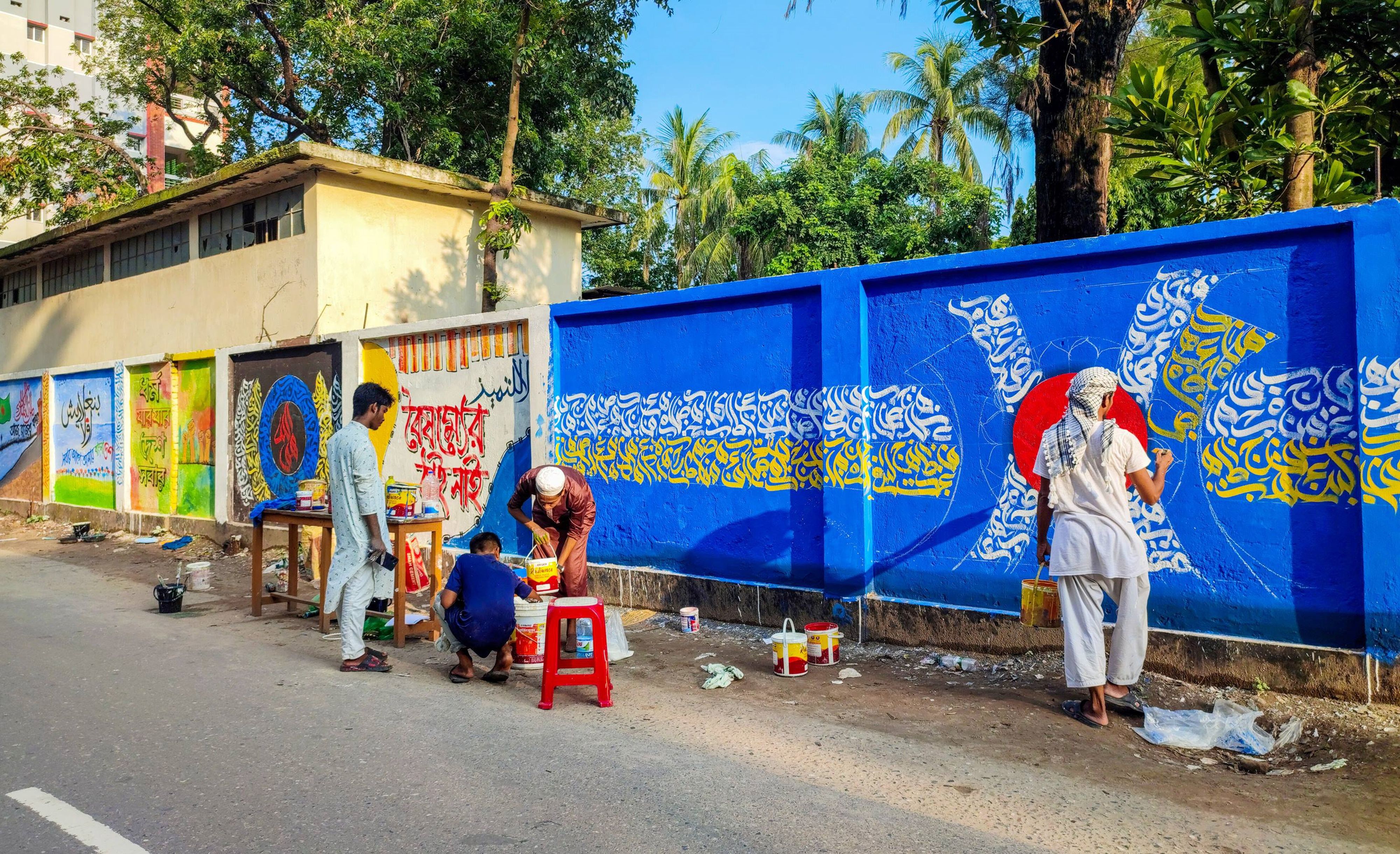 Street Artists Painting Colorful Mural on Urban Wall · Free Stock Photo