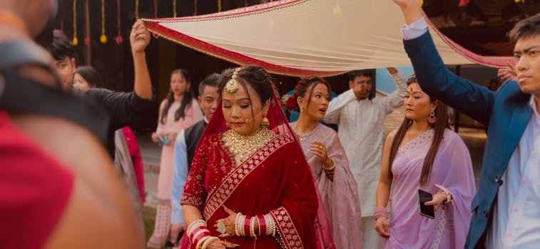 Bride in red traditional attire during a vibrant Indian wedding procession.