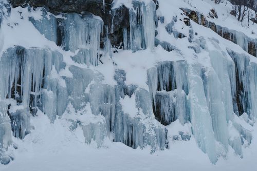 Free Stunning frozen ice formations on a cliff in a snowy Arctic landscape. Stock Photo