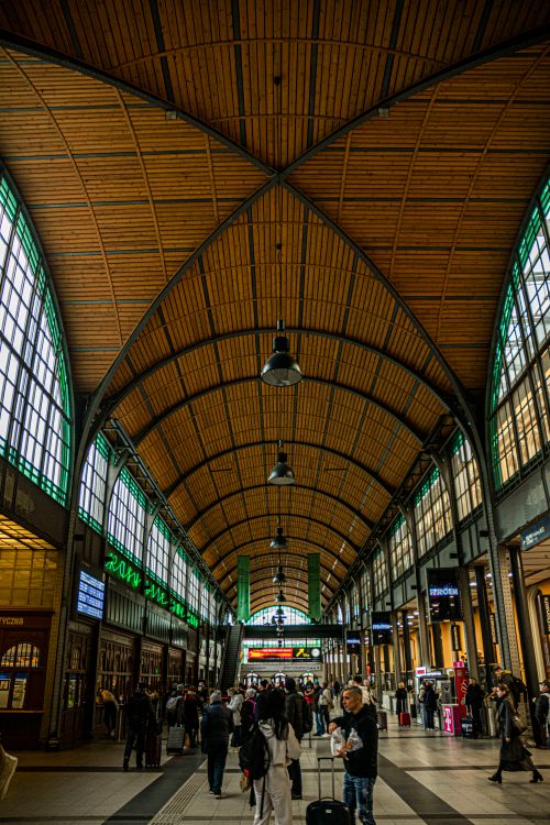 Free Vibrant railway station with arched wooden ceiling and busy commuters. Stock Photo