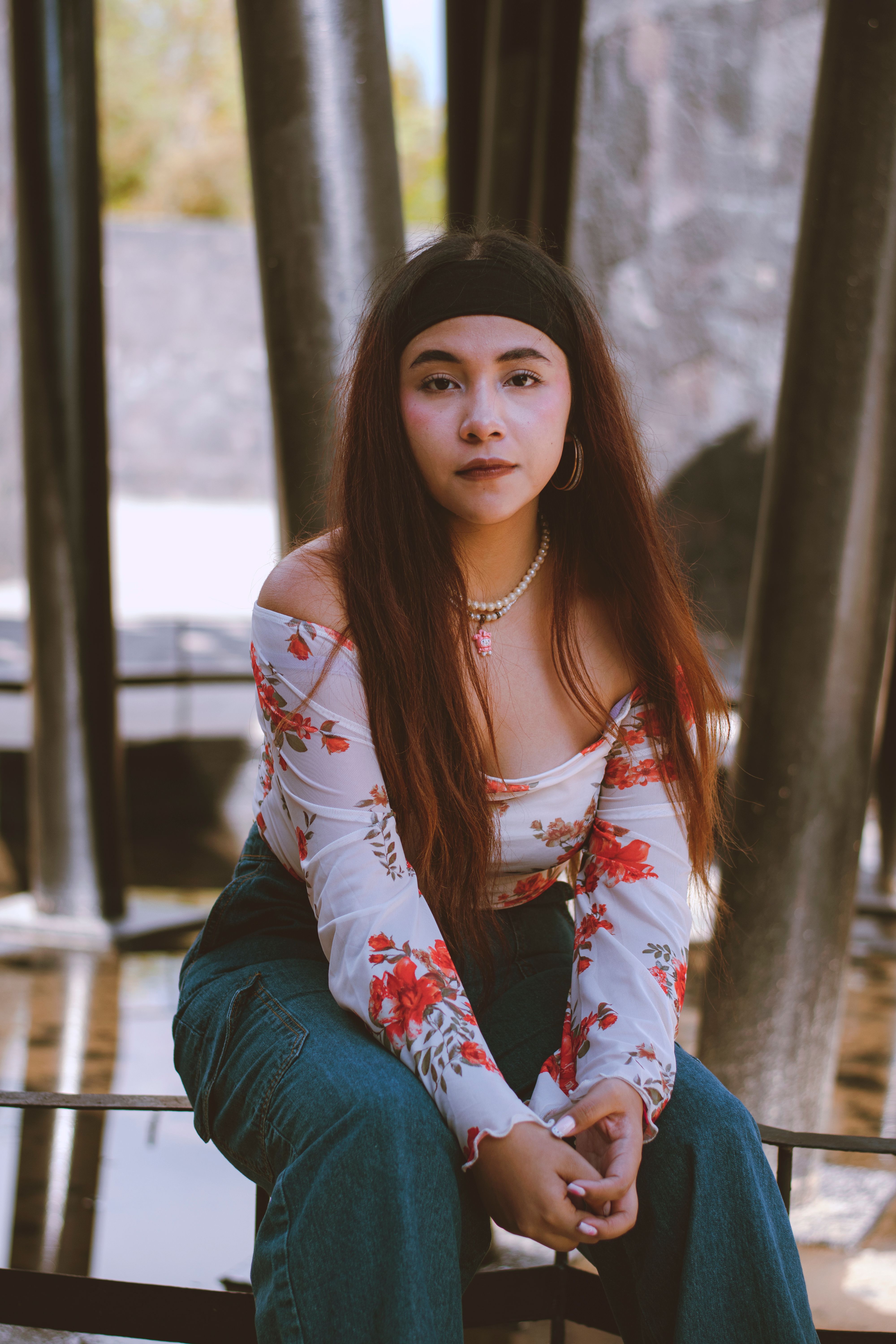 Young Woman Posing Outdoors in Floral Top · Free Stock Photo