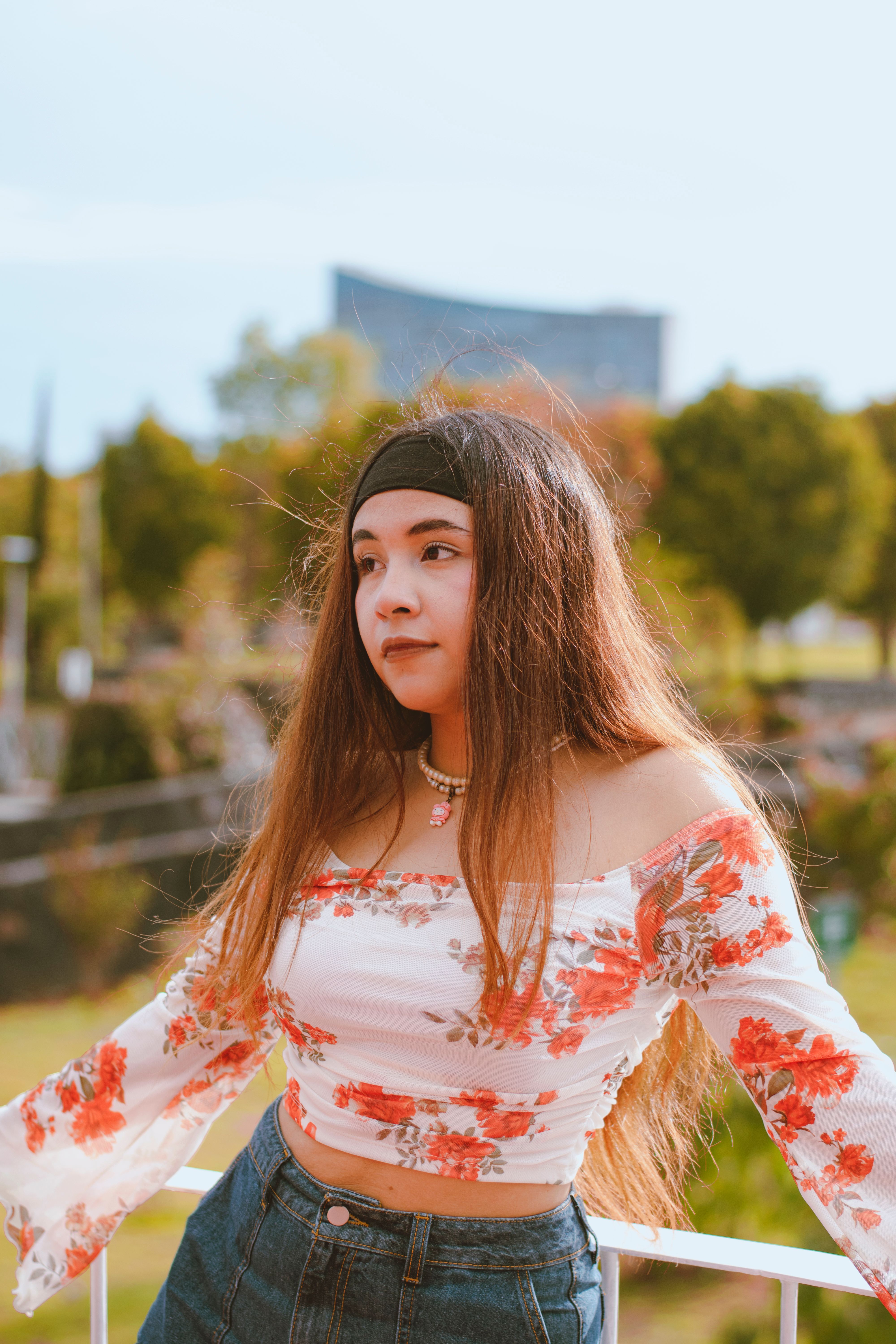 Young Woman Posing Outdoors in Floral Top · Free Stock Photo