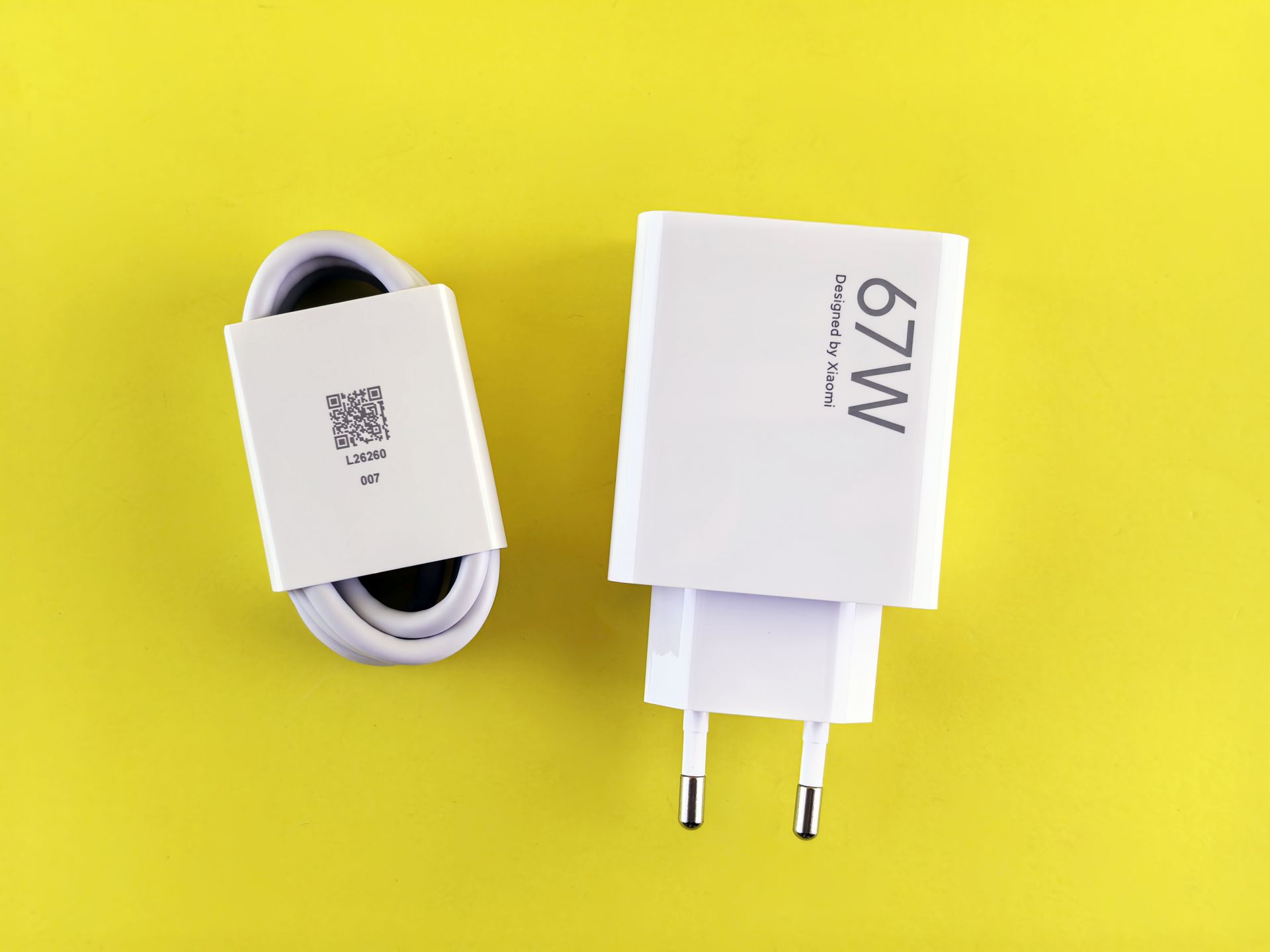67W charger and cable set on a vibrant yellow background, showcasing charging technology.