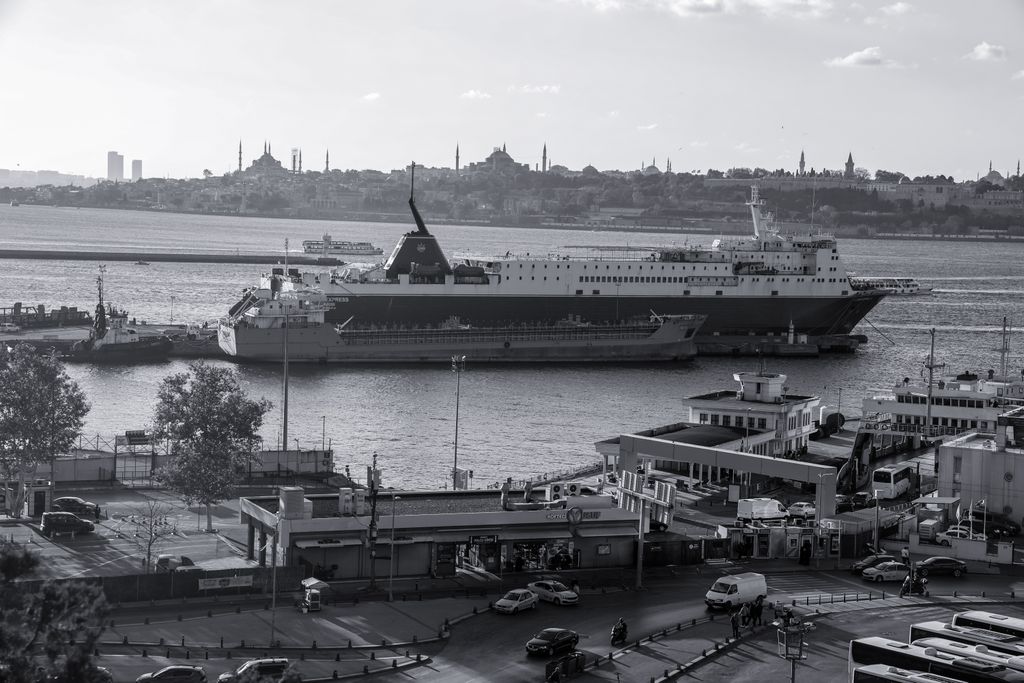 Black-and-white photo of a ferry on the Bosphorus with Istanbul's historic skyline behind
