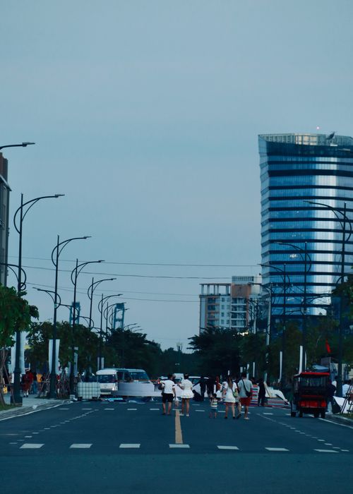 Free A vibrant city street with people and modern buildings in daylight. Stock Photo