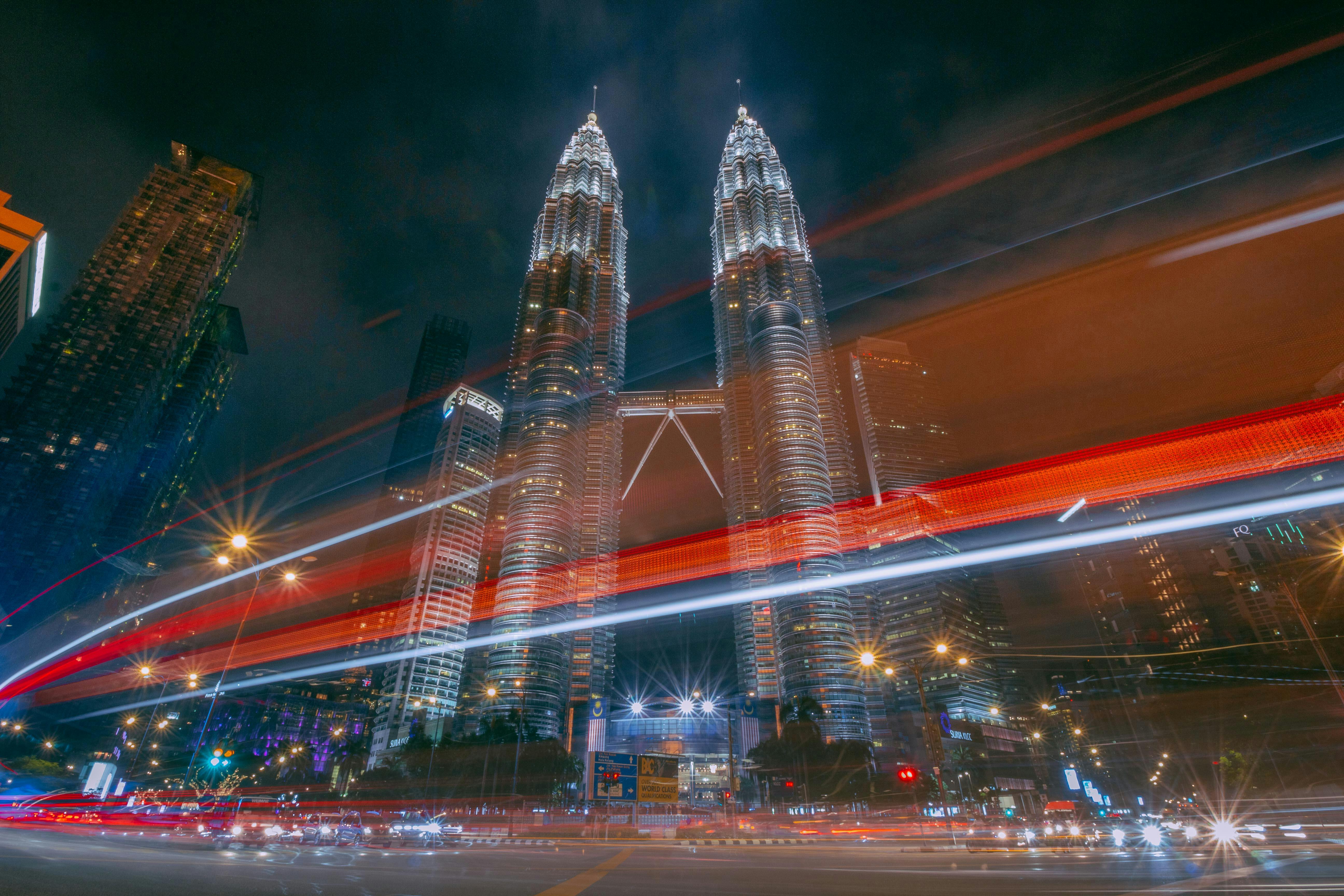 time lapse photography of petronas twin tower at city of malaysia