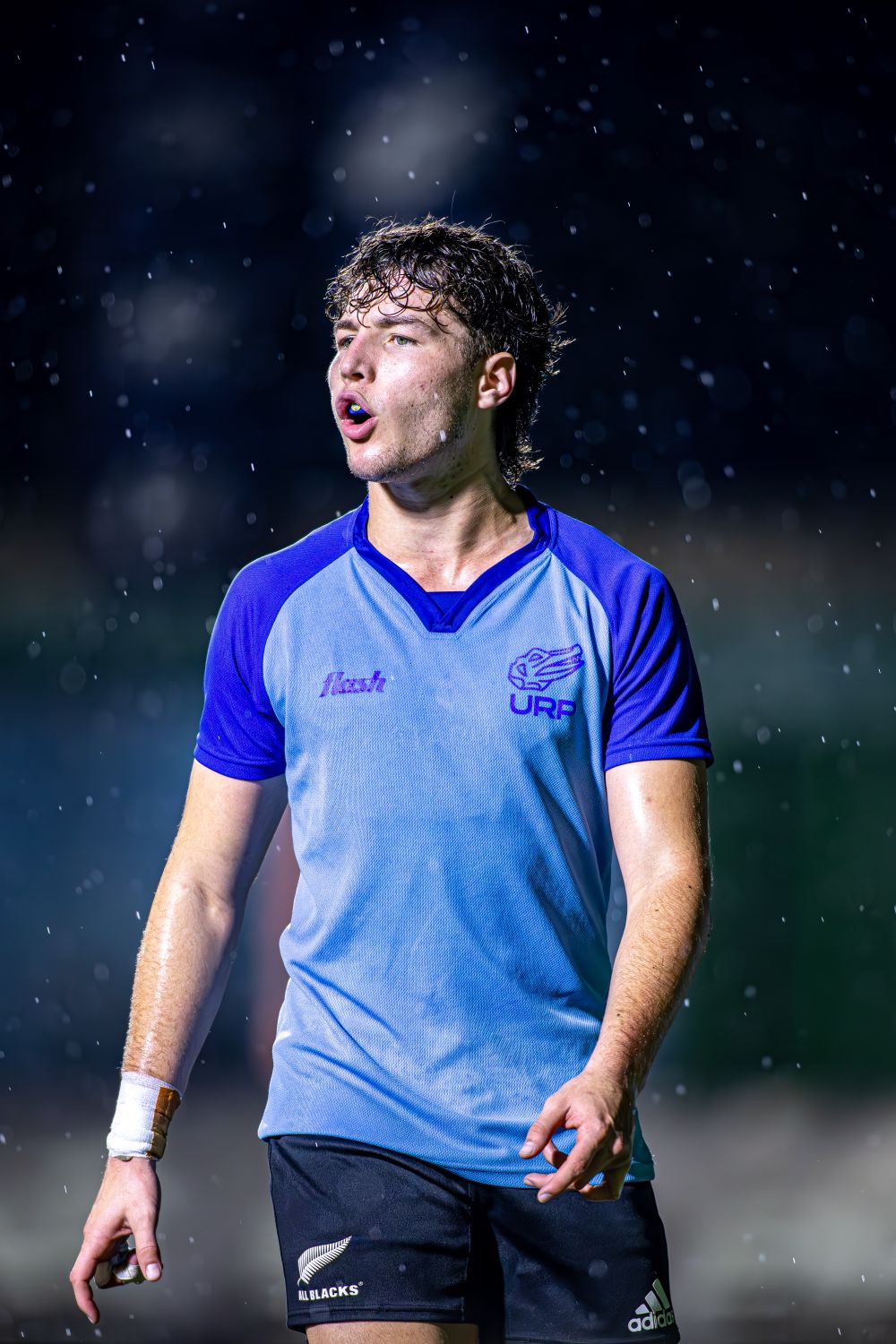 Marcus Bell, Skarnwick quarterback, in the rain during a night match