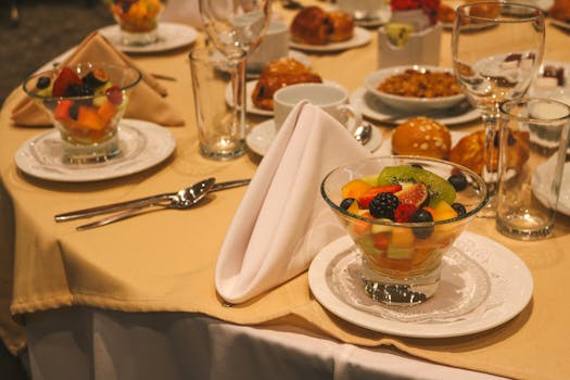 Elegant table setting featuring glasses of fresh fruit salad, perfect for dining ambiance.