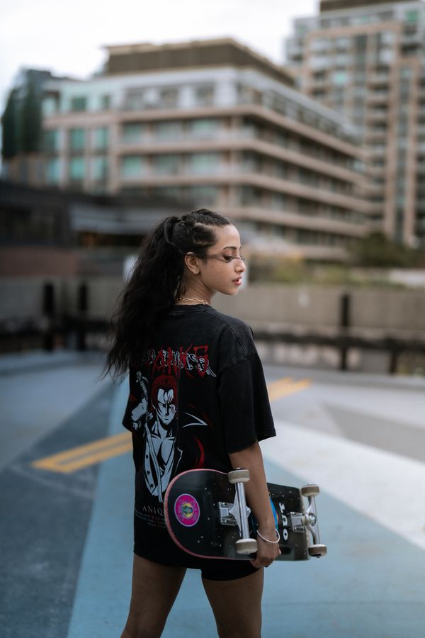 woman wearing oversized graphic tee as dress street style