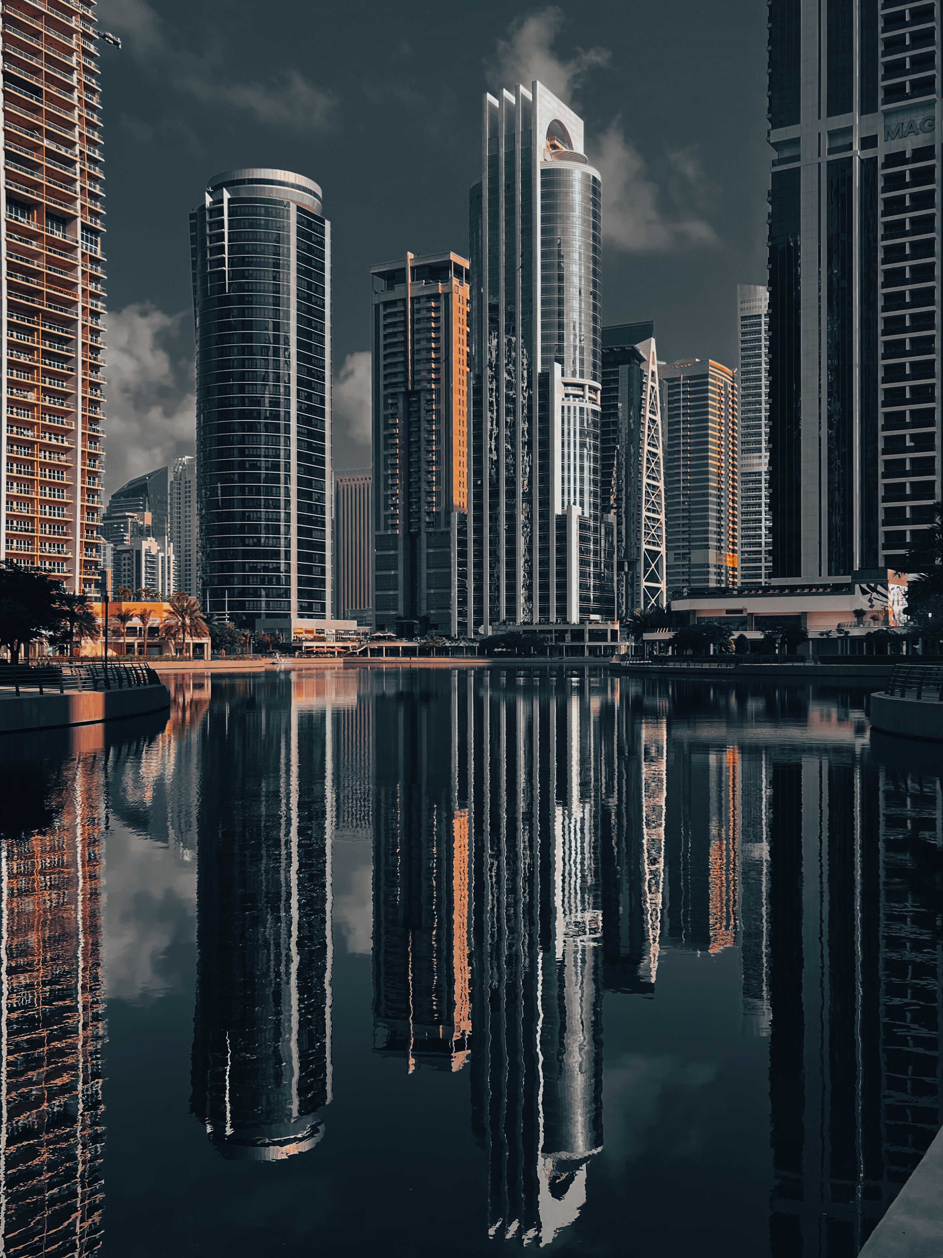 A captivating view of Dubai's skyscrapers reflecting in the calm water, highlighting modern architecture.