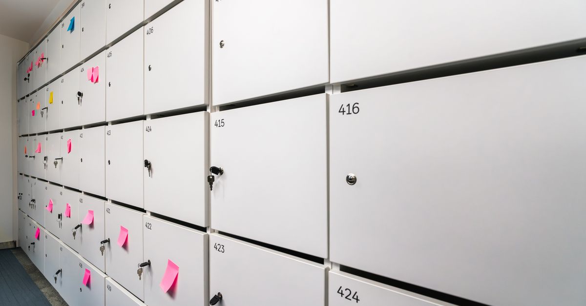 Row of white lockers with colorful sticky notes and numbers, ideal for office organizing theme.
