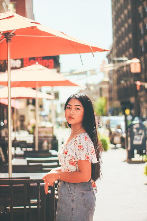 Free Woman Standing Near High-rise Buildings Stock Photo