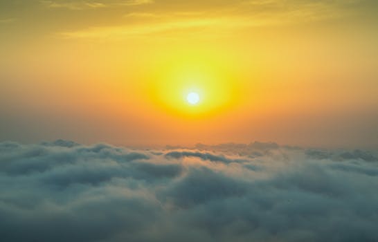 Golden sunrise over clouds, creating a serene and dreamlike morning landscape.