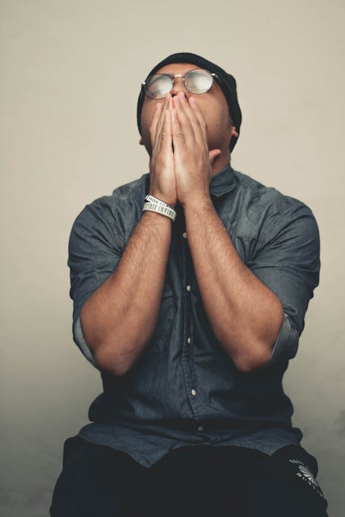 Free Man Holding His Face Stock Photo