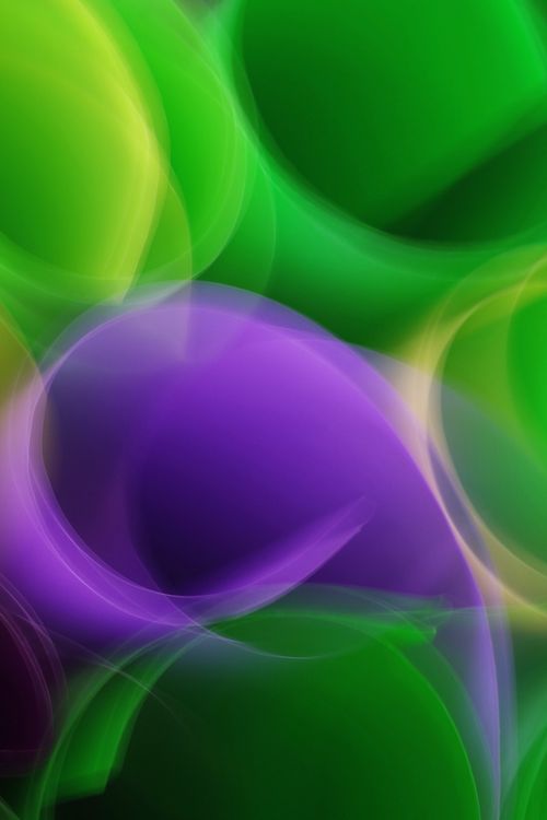 Free Vibrant abstract light swirls with green and purple hues creating dynamic movement. Stock Photo