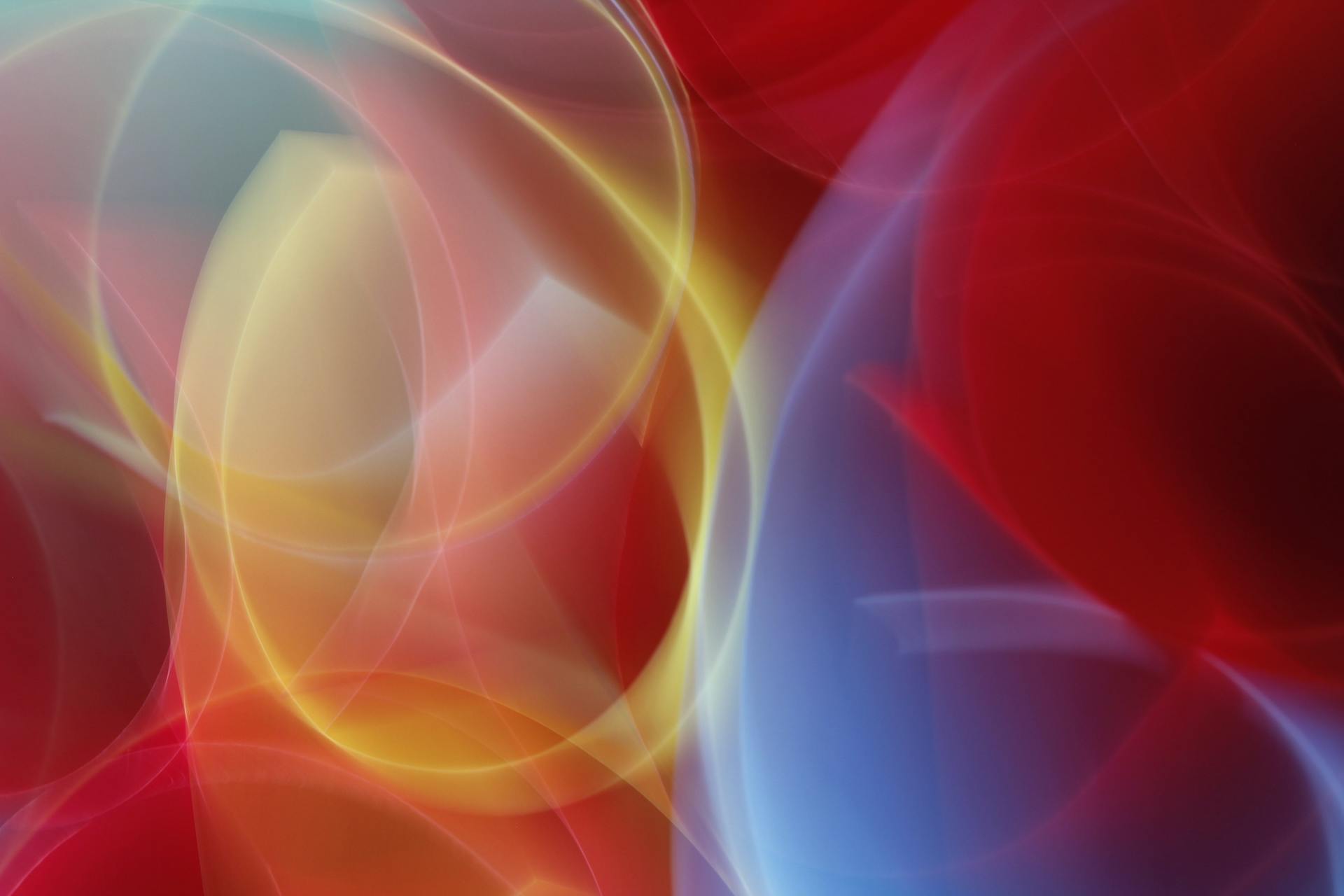 Dynamic abstract image with colorful light patterns and fluid shapes.