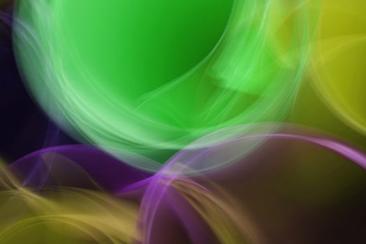 Colorful abstract image featuring green, purple, and yellow light trails in artistic motion.