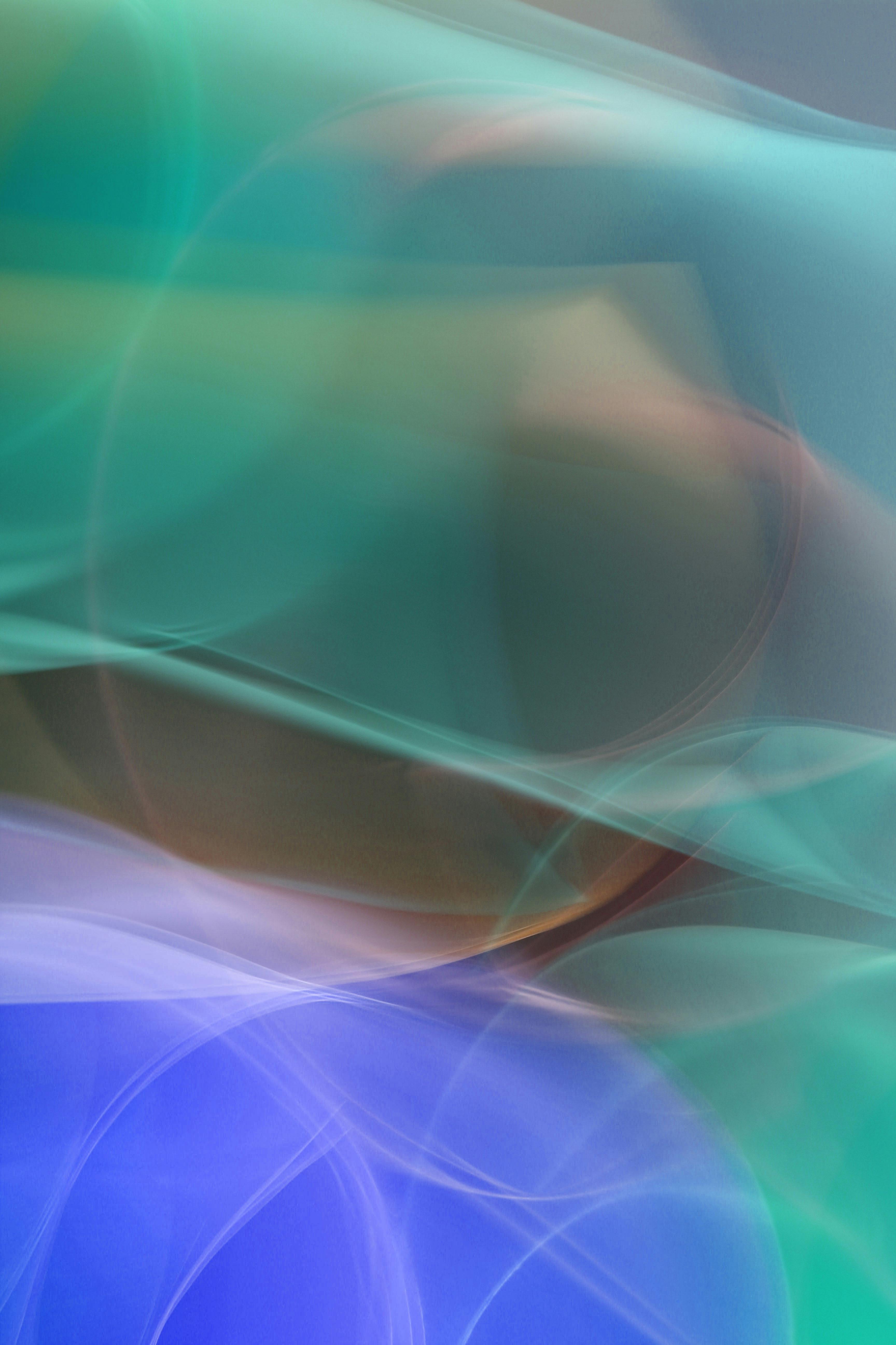 Abstract image featuring colorful swirling light waves, creating a dreamy and ethereal effect.