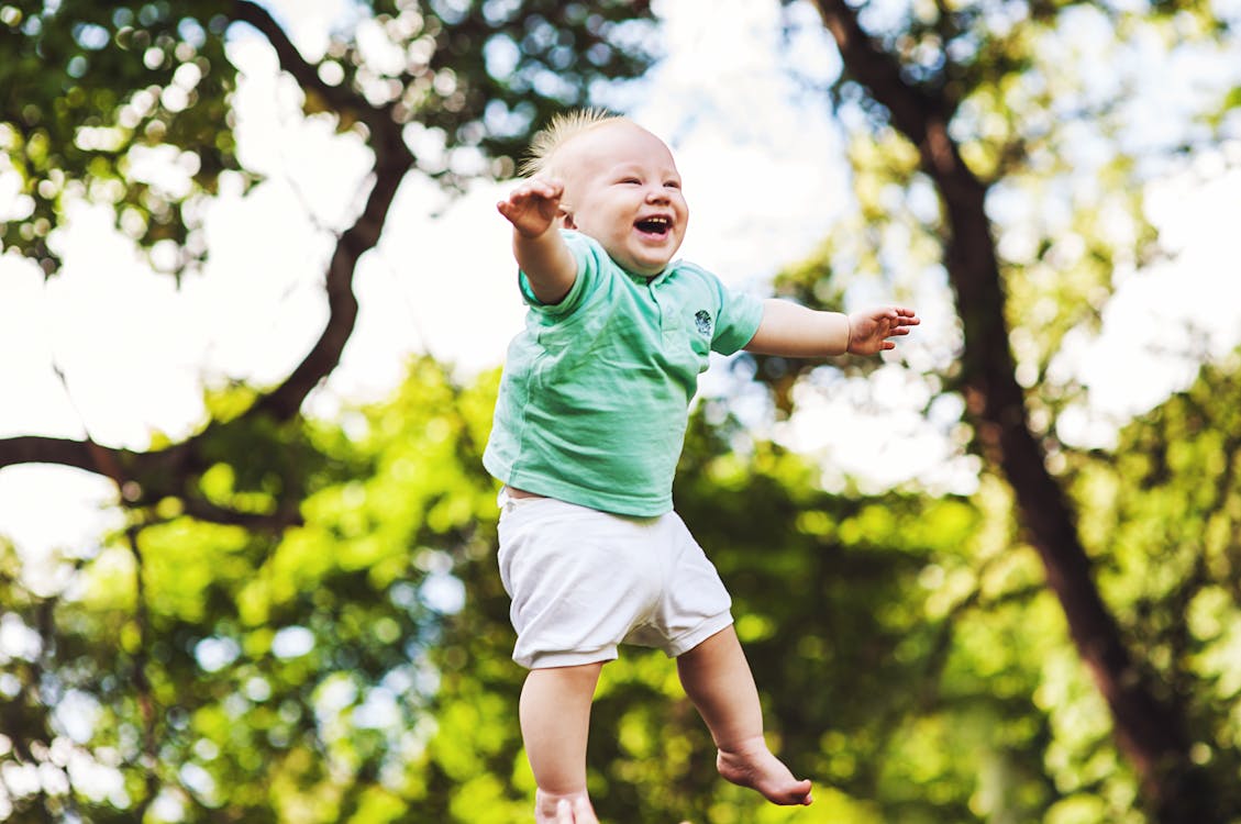 Free Laughing Baby Floating on Air Stock Photo