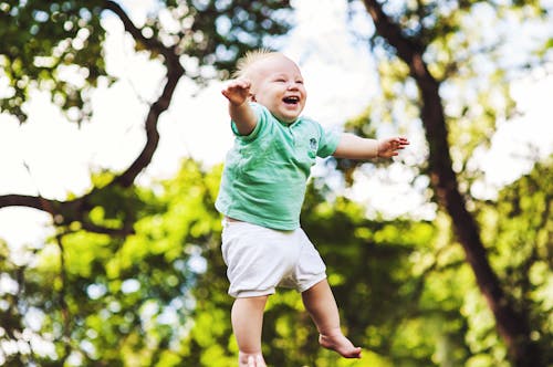 Free Laughing Baby Floating on Air Stock Photo