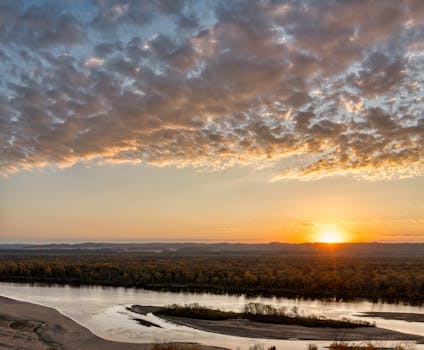A beautiful autumn sunrise over the Mississippi River with vibrant skies.