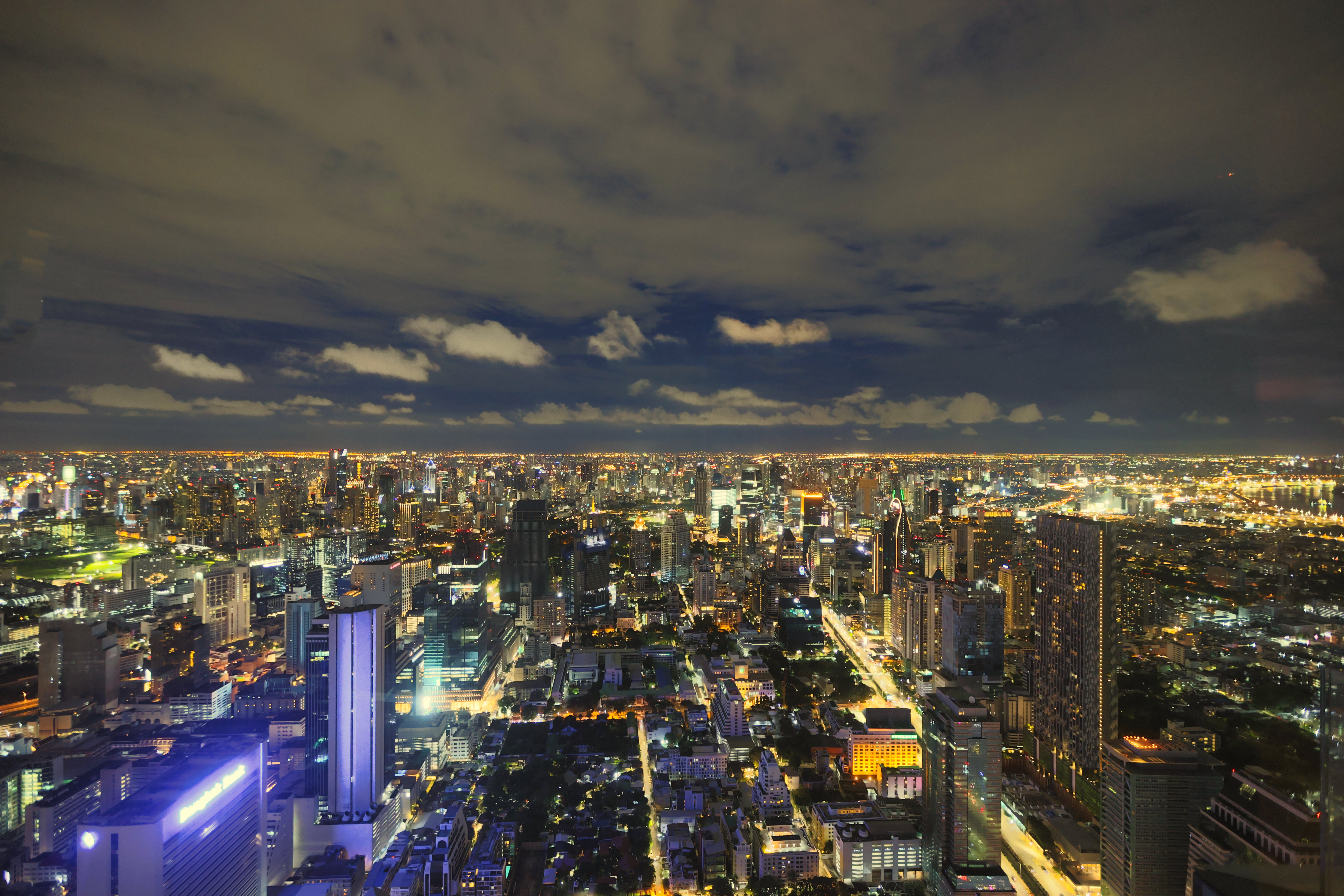 Illuminated Bangkok skyline at night — viewed from Lebua/State Tower's signature rooftop bar
