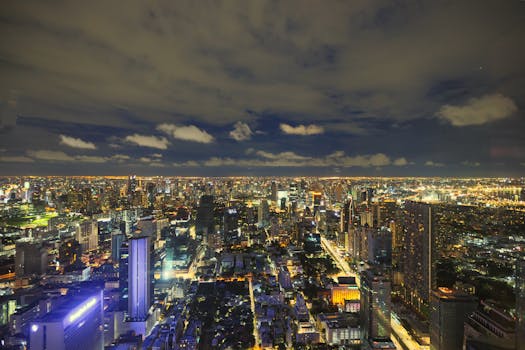 A captivating view of Bangkok's illuminated skyline at night, showcasing its modern architecture.