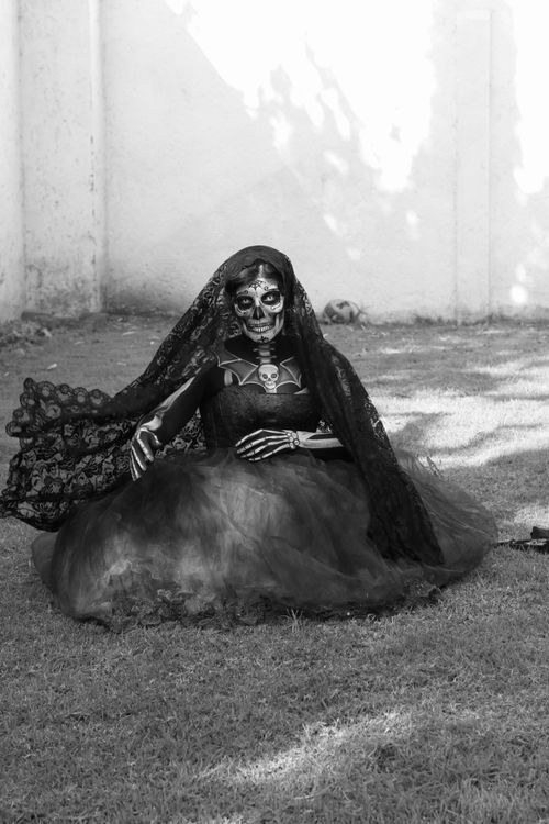 Free Black and white photo of a person in a skeleton costume and veil outdoors. Stock Photo