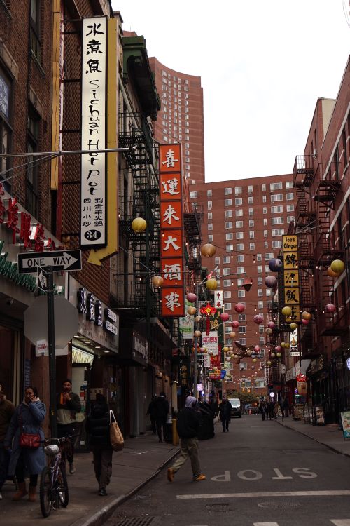 Free Vibrant scene in New York City's Chinatown with people, shops, and lanterns on a busy street. Stock Photo