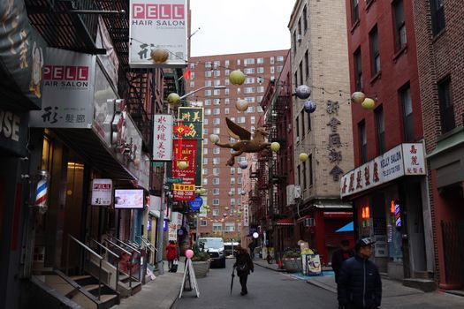 Street view of a busy Chinatown neighborhood in New York City.