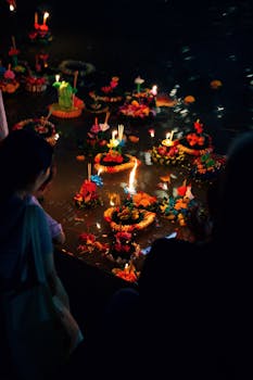 Floating lanterns at the Loi Krathong festival in Bangkok creating a vibrant night atmosphere.